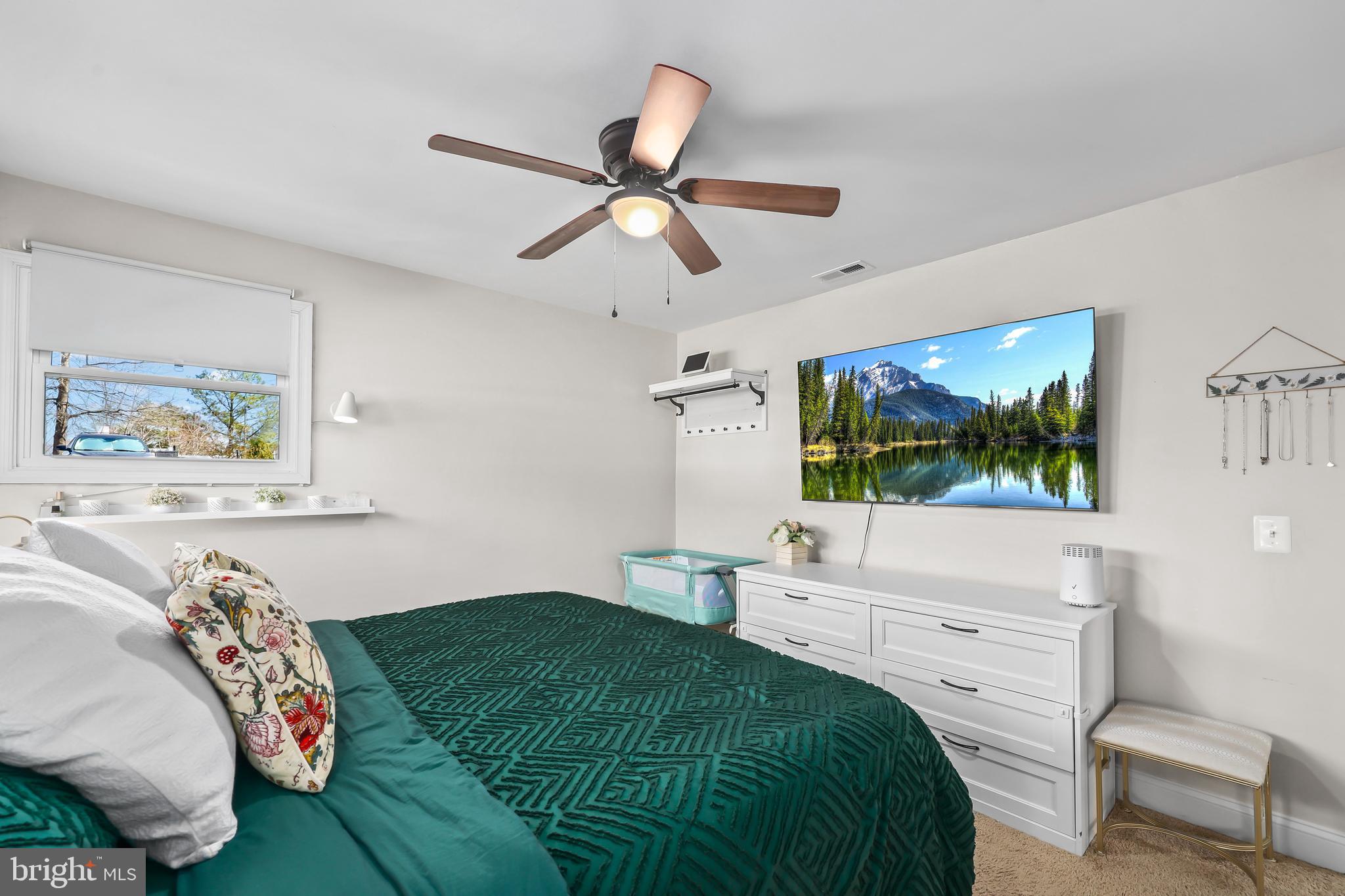 379 Ferry Road Fredericksburg, VA 22405 - Photo 16 of 33 a bedroom with a bed and a flat screen tv