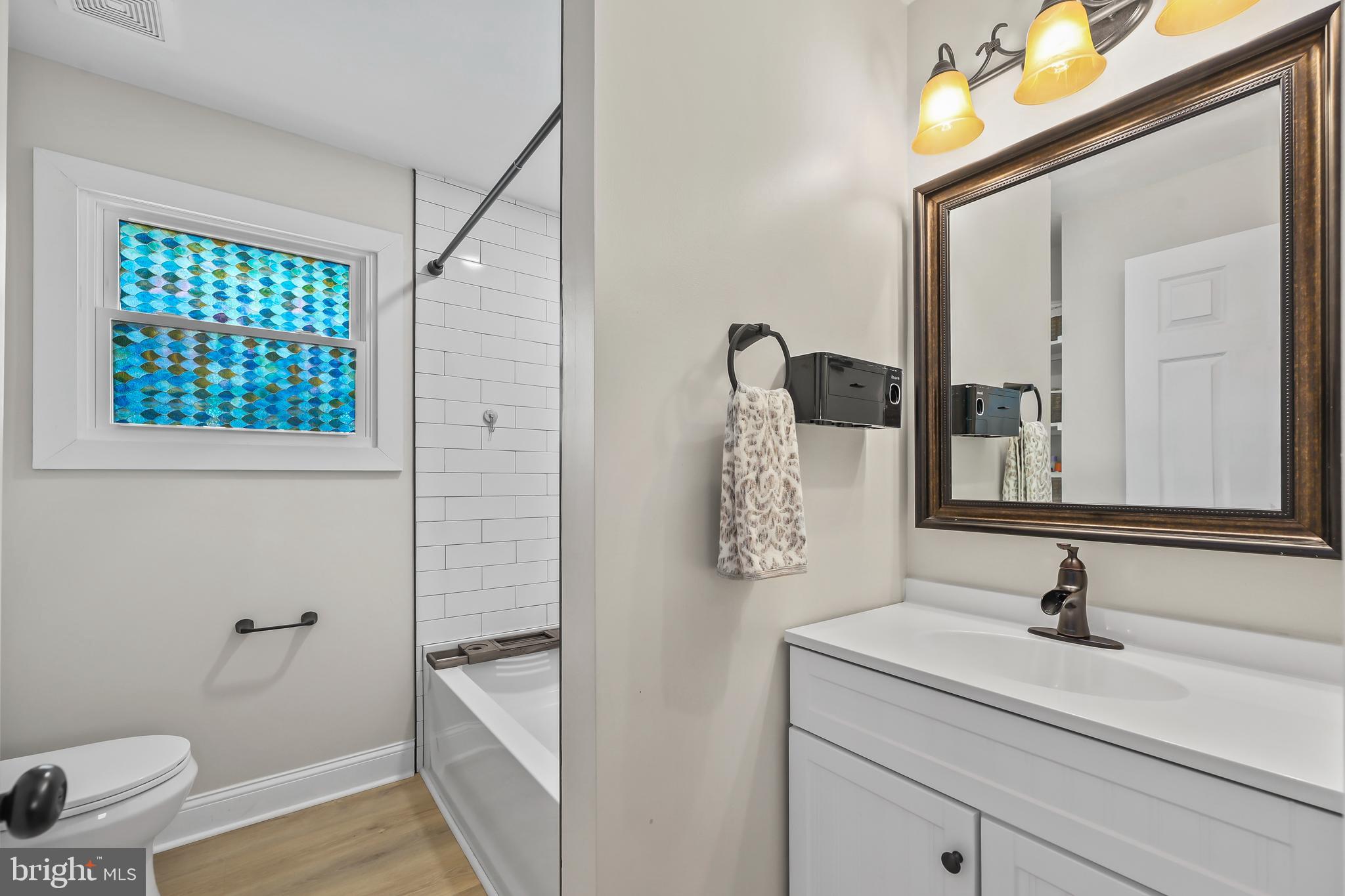 379 Ferry Road Fredericksburg, VA 22405 - Photo 17 of 33 a bathroom with a granite countertop sink and a mirror