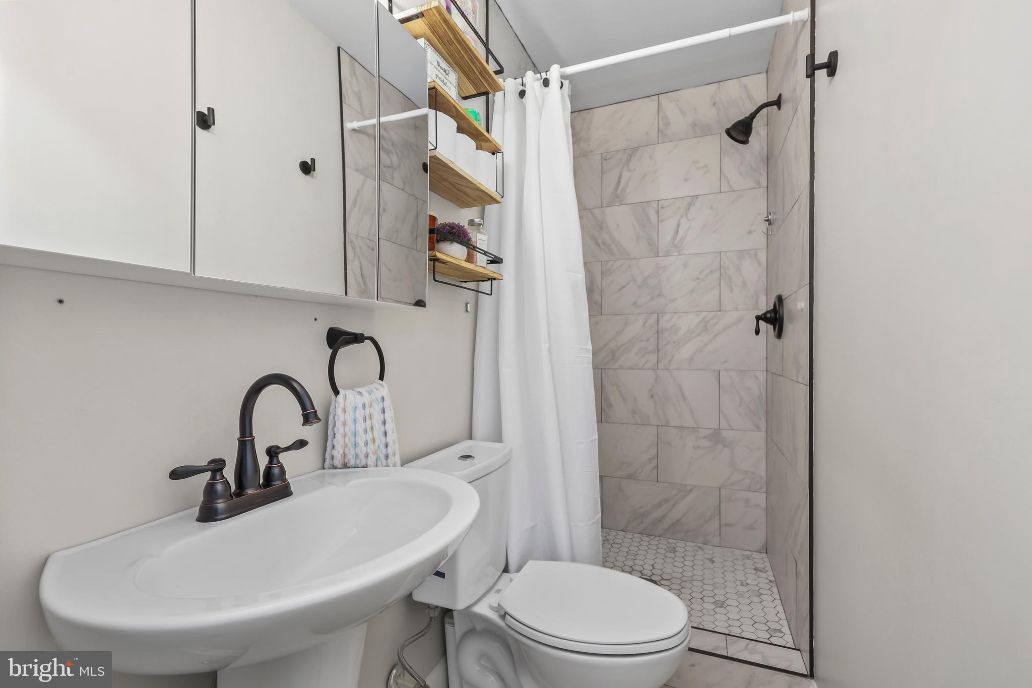 379 Ferry Road Fredericksburg, VA 22405 - Photo 22 of 33 a bathroom with a sink toilet and shower
