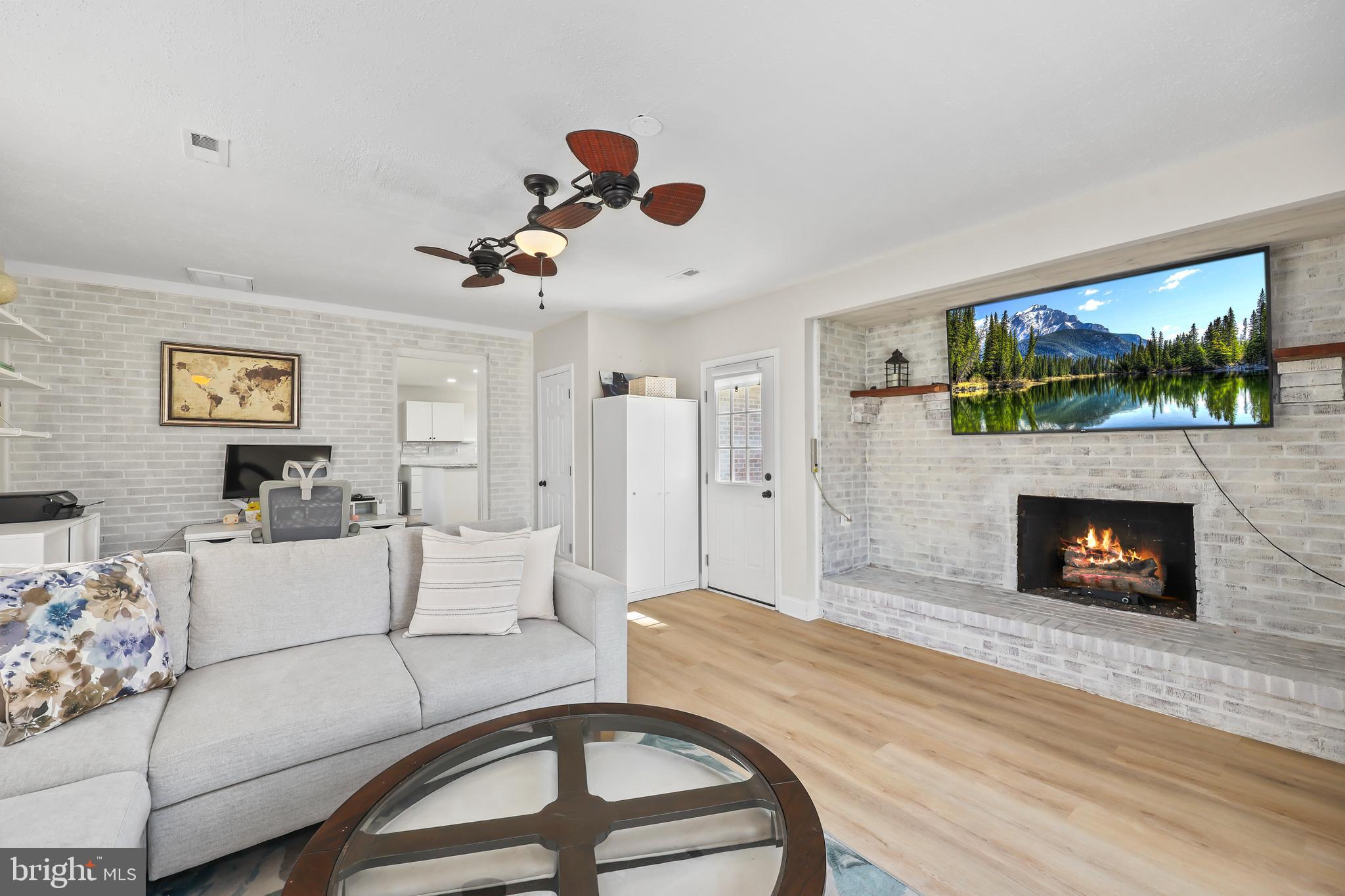 379 Ferry Road Fredericksburg, VA 22405 - Photo 4 of 33 a living room with furniture a flat screen tv and a fireplace