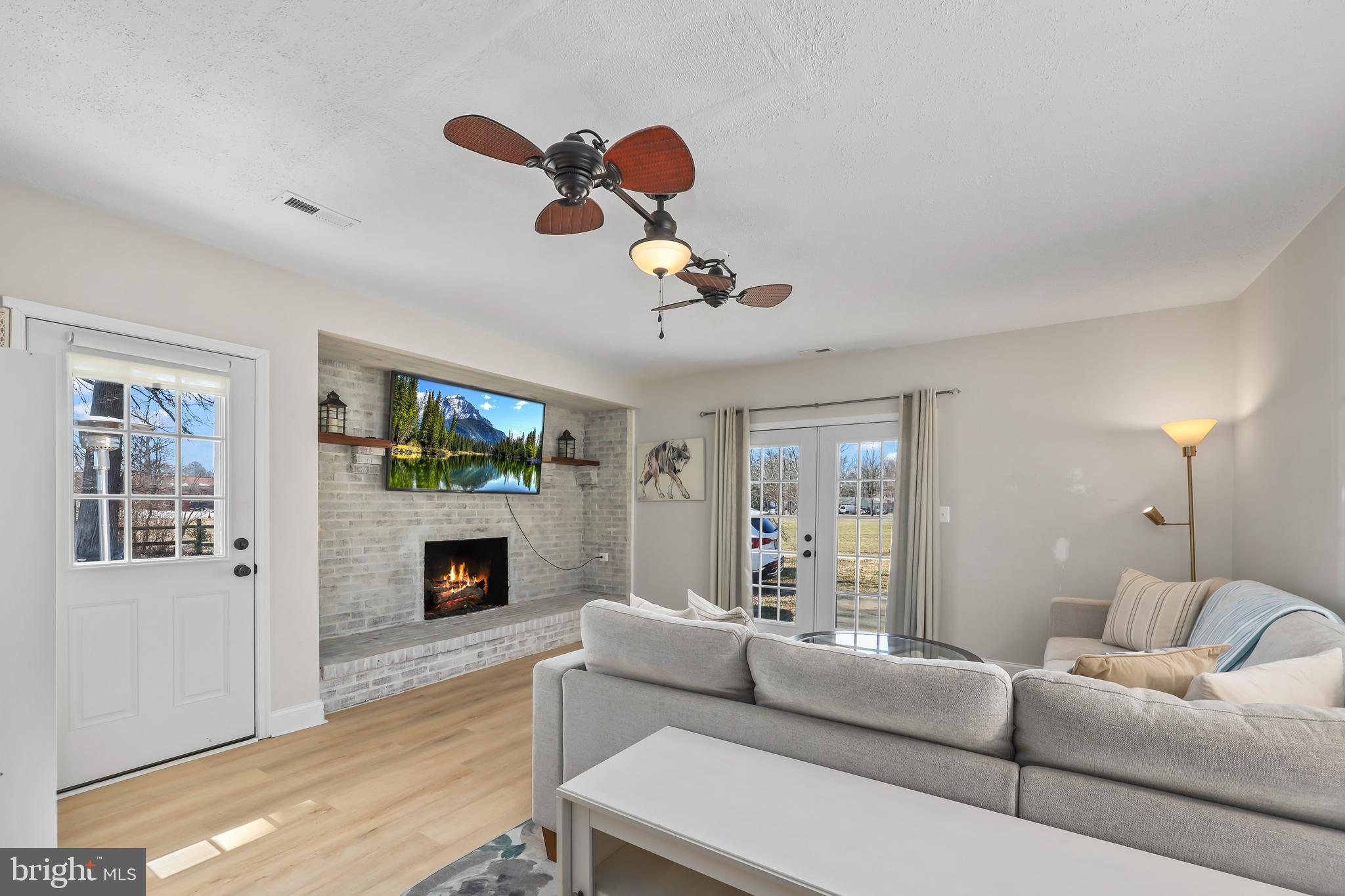379 Ferry Road Fredericksburg, VA 22405 - Photo 5 of 33 a living room with furniture a fireplace and a flat screen tv