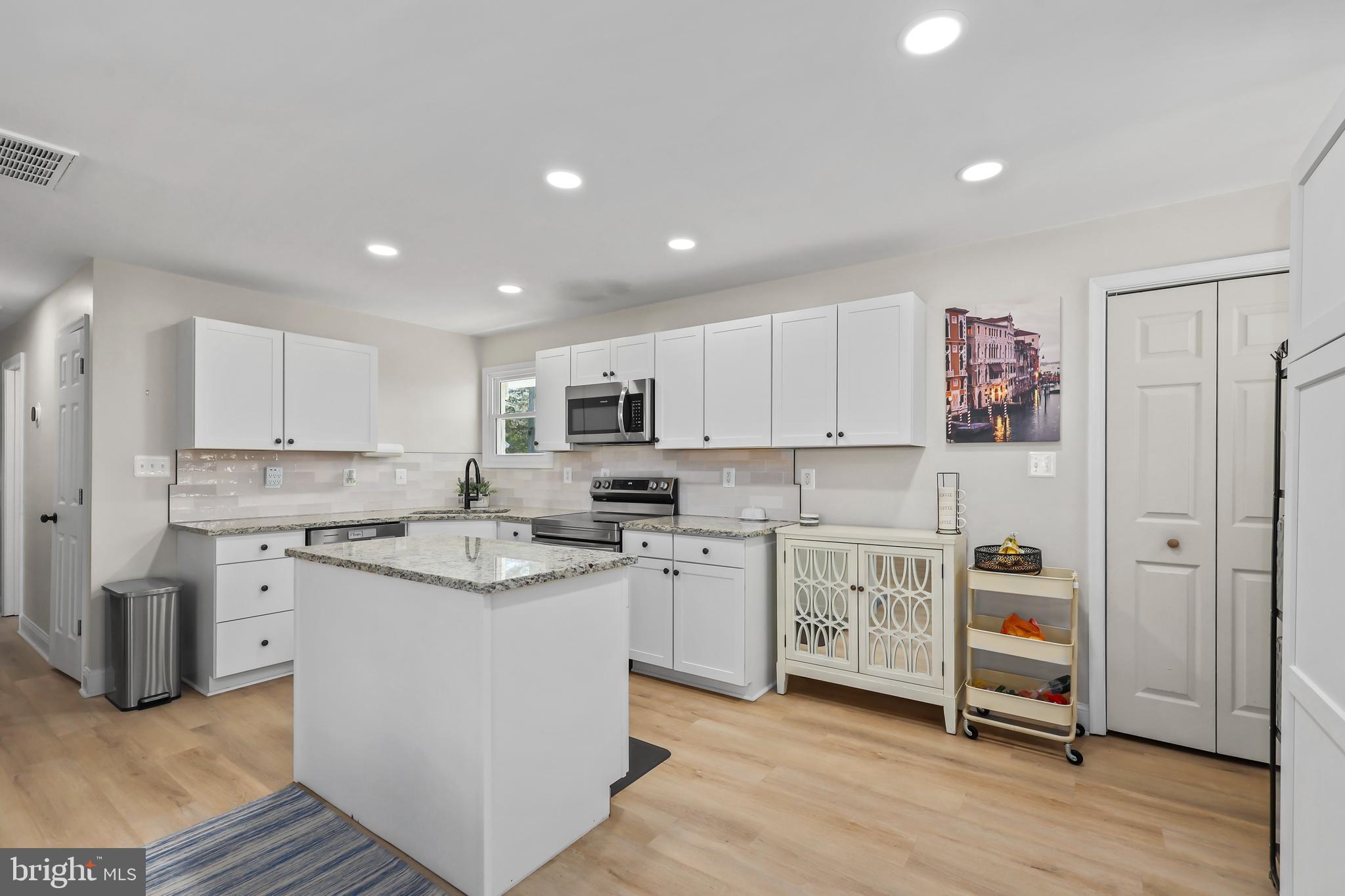379 Ferry Road Fredericksburg, VA 22405 - Photo 10 of 33 a kitchen with cabinets and wooden floor