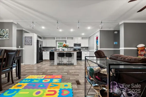 a kitchen with stainless steel appliances kitchen island granite countertop a sink and a stove