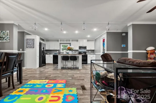 a kitchen with stainless steel appliances kitchen island granite countertop a sink and a stove