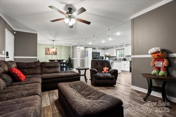 a living room with furniture and kitchen view