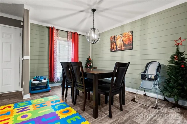 a view of a dining room with furniture and a chandelier