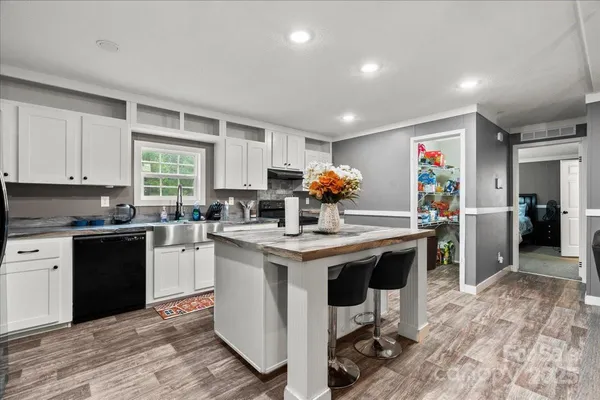 a kitchen with a sink cabinets and window