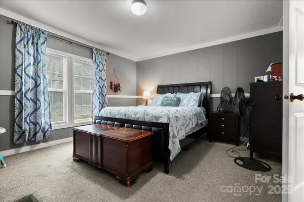 a bed room with a bed and a window