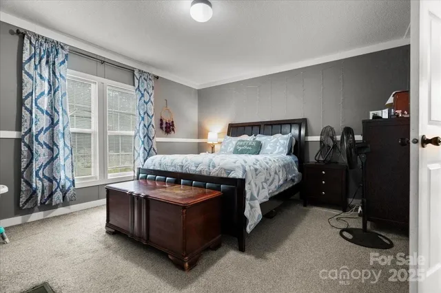 a bed room with a bed and a window