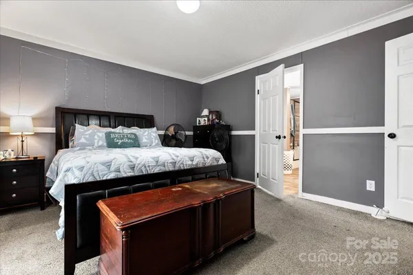 a bedroom with a bed and a night stand