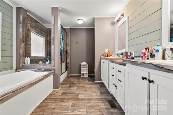 a spacious bathroom with a double vanity sink and a large mirror