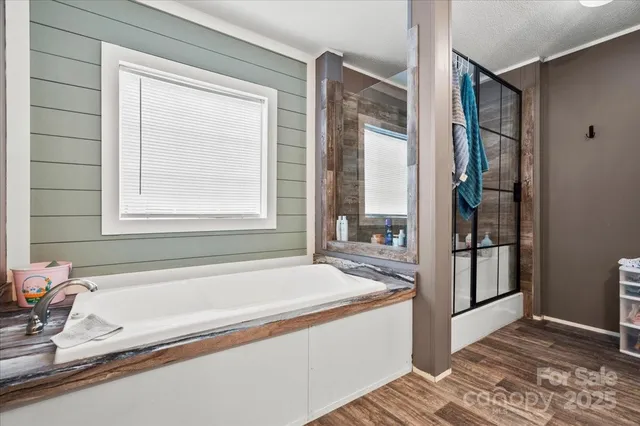 a spacious bathroom with a bathtub and a shower