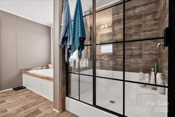 a bathroom with a bathtub and shower