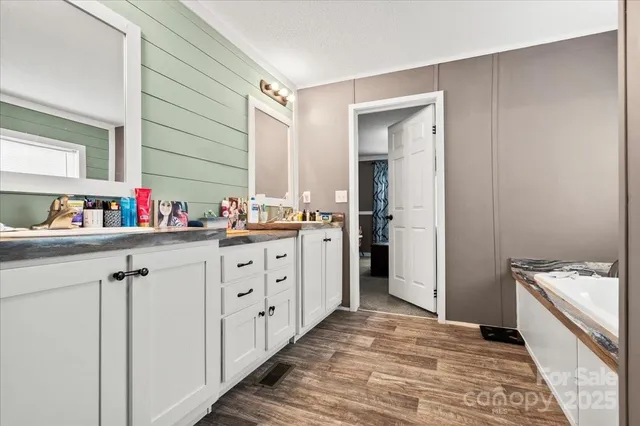 a kitchen with granite countertop a sink stove and cabinets