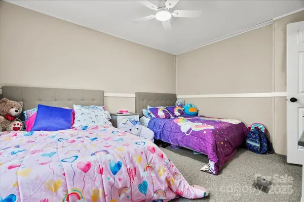 a bedroom with two beds and painted walls