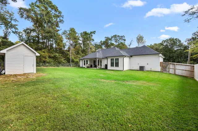 a view of a backyard with large trees