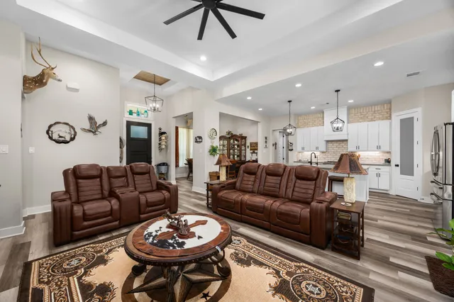 a living room with furniture a rug and a chandelier