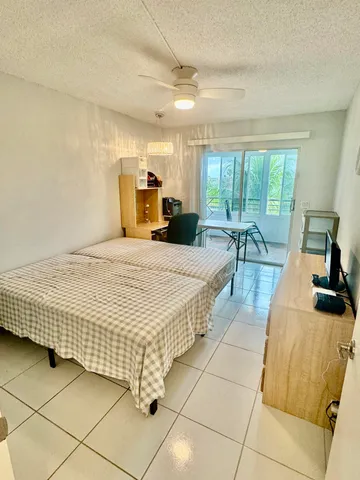 a bed room with a bed and a large window