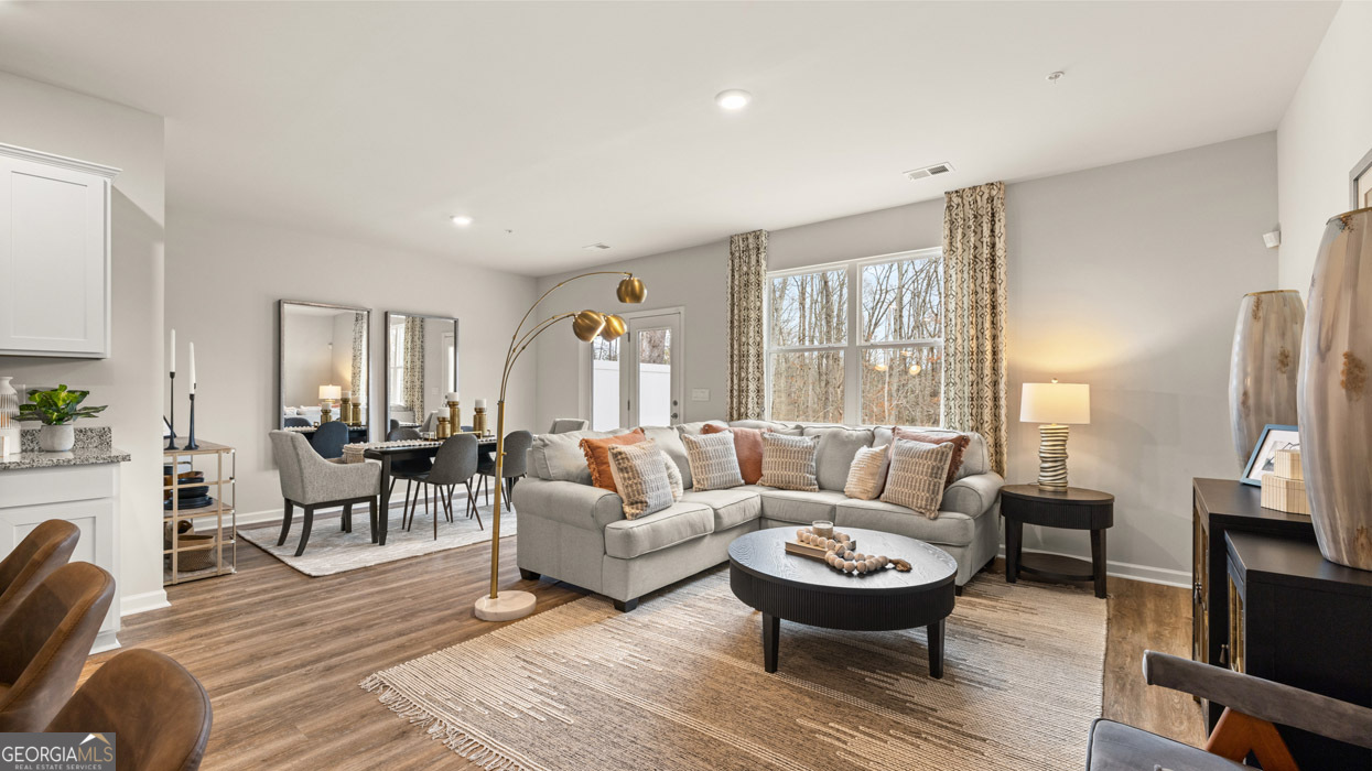241 Sound Circle Stockbridge, GA 30281 - Photo 27 of 64 a living room with furniture a large window and a flat screen tv