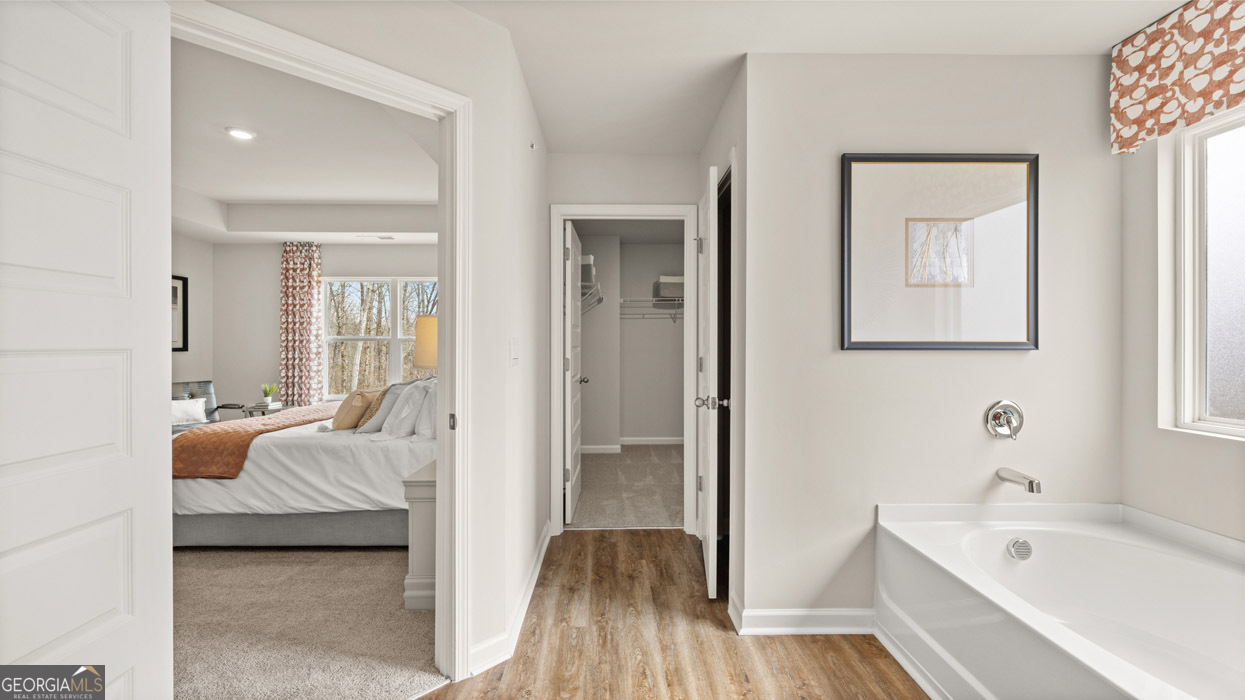 241 Sound Circle Stockbridge, GA 30281 - Photo 44 of 64 a bedroom with a bed and a view of bathroom