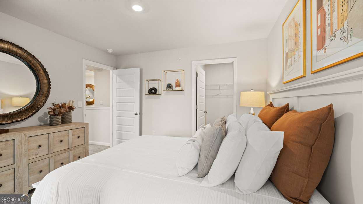 241 Sound Circle Stockbridge, GA 30281 - Photo 53 of 64 a bedroom with a bed a mirror and a window