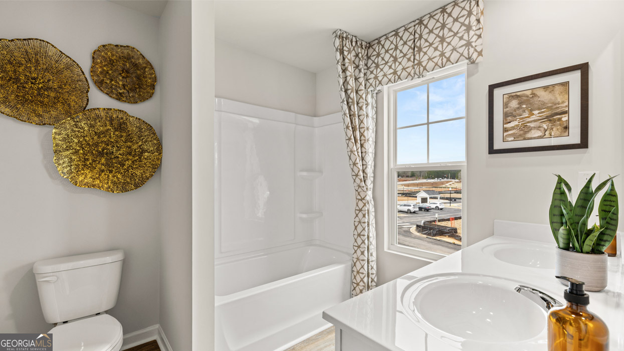 241 Sound Circle Stockbridge, GA 30281 - Photo 60 of 64 a bathroom with a toilet and a sink