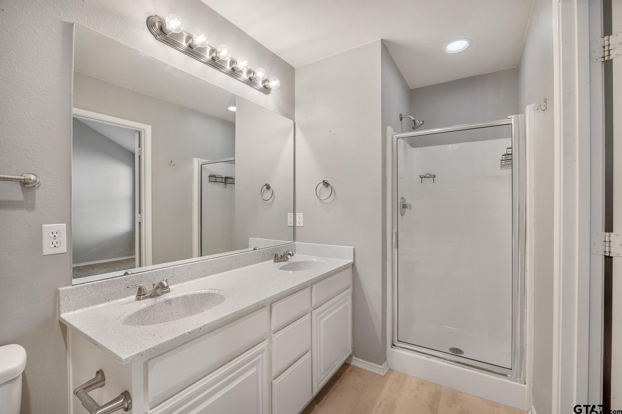 7000 Ranch Hill Drive Flint, TX 75762 - Photo 14 of 25 a bathroom with a sink double vanity and a mirror