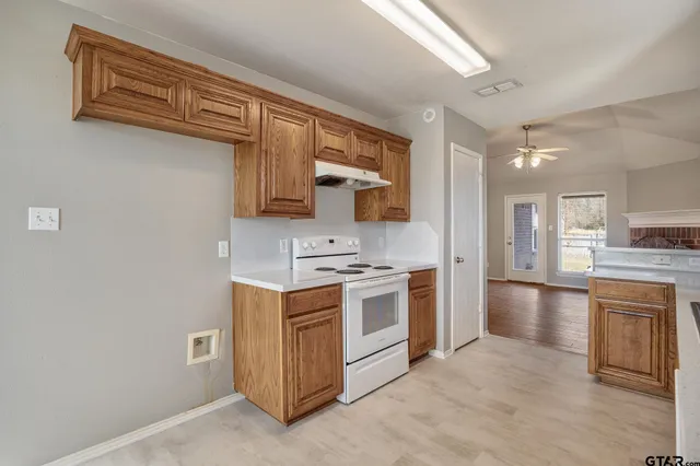 a kitchen with a stove and a refrigerator