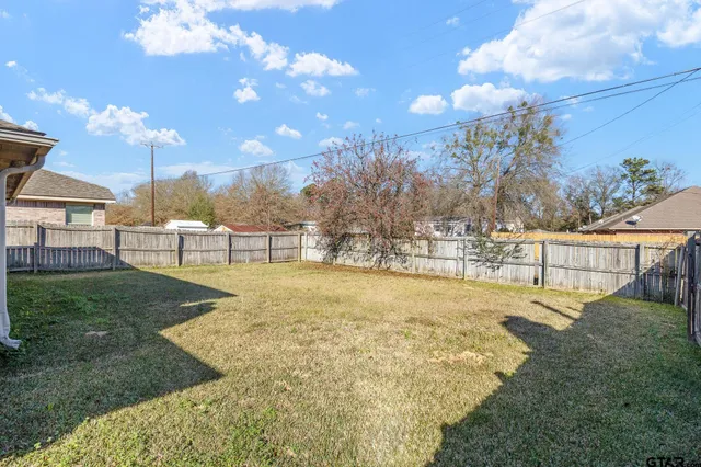 a view of a yard with swimming pool