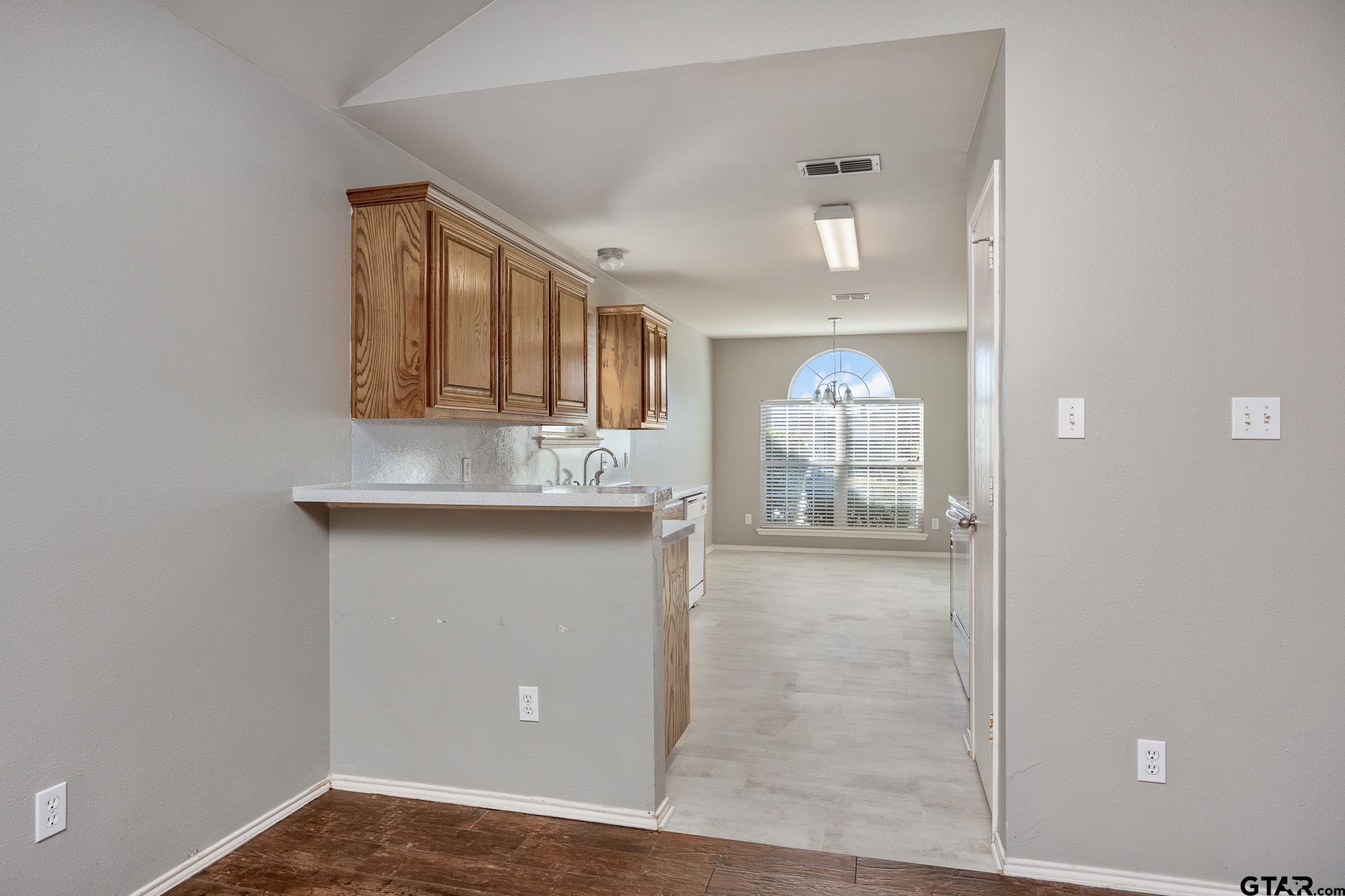7000 Ranch Hill Drive Flint, TX 75762 - Photo 9 of 25 a view of a hallway to a room with wooden floor and cabinet