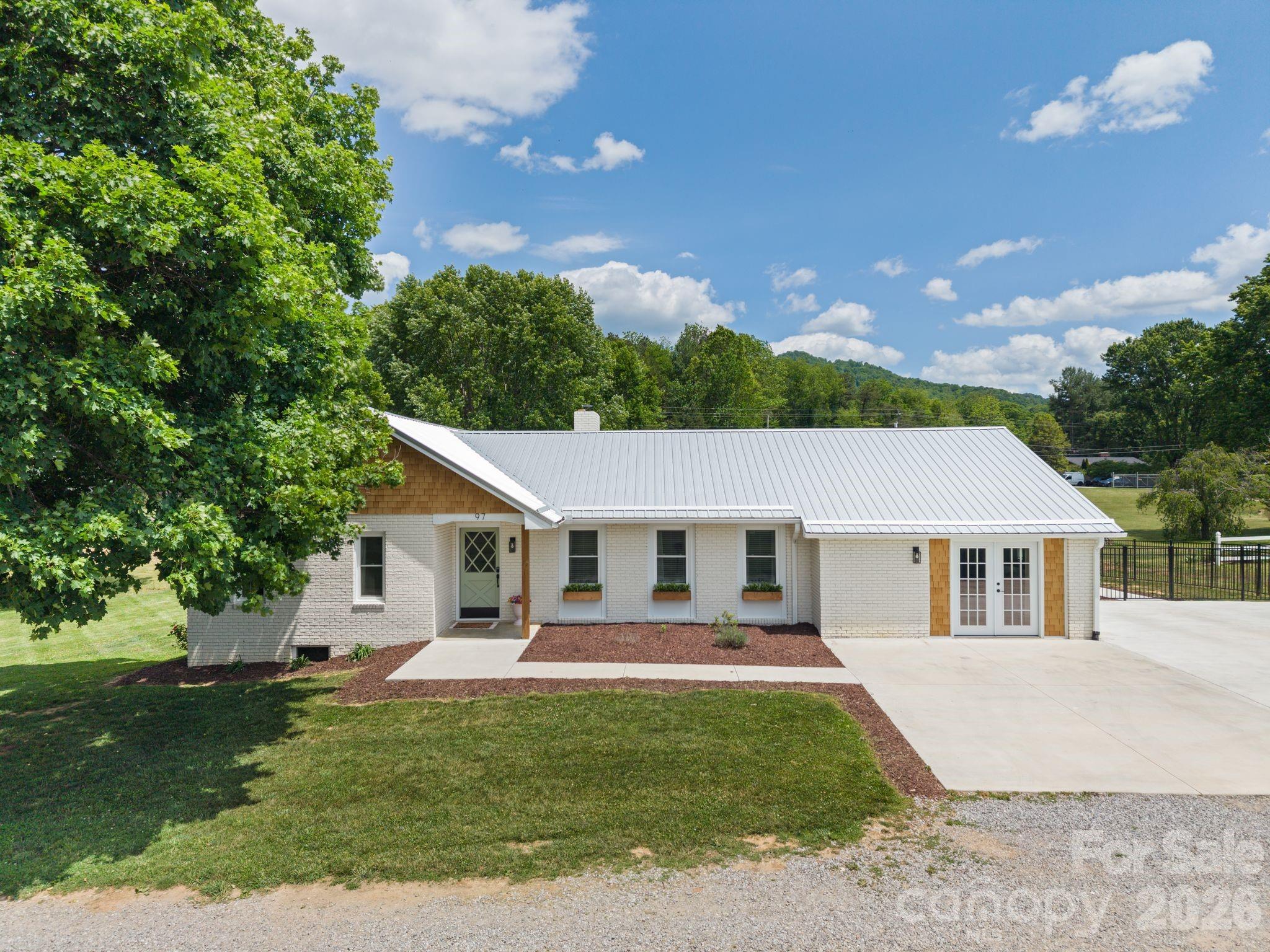 97 Paul Holland Road Canton, NC 28716 - Photo 5 of 35 a front view of a house with a garden