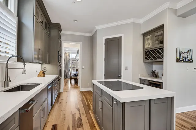 a kitchen with a sink stove and cabinets