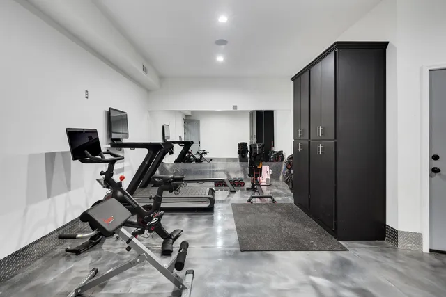 a bedroom with a bed and a flat tv screen