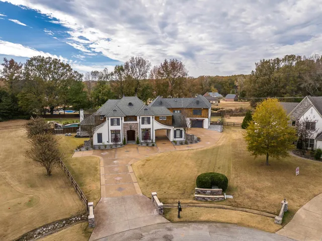 an aerial view of a house with swimming pool and sitting area