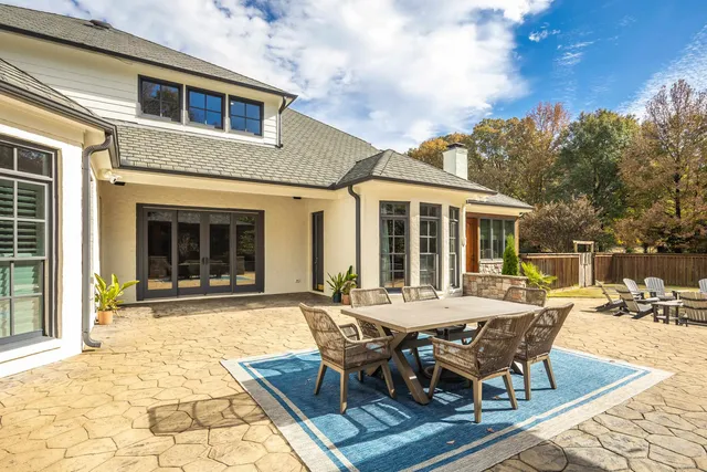 a view of a dining room with furniture large windows and wooden floor