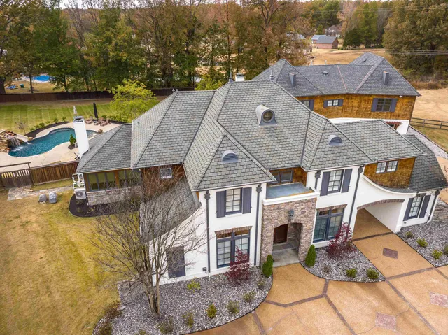 an aerial view of a house with a ocean view