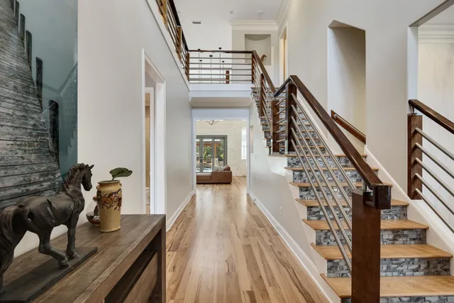 a view of entryway and hall with wooden floor