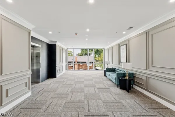 a large white room with large windows and furniture