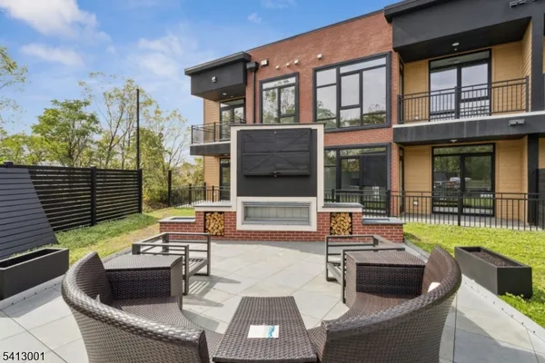 a view of a patio with couches table and chairs and potted plants