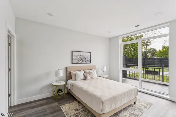 a bedroom with a bed and a large window