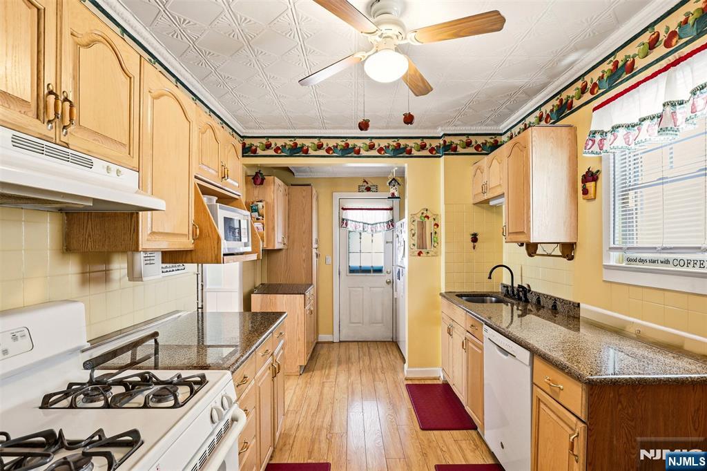 332 Riverside Avenue Lyndhurst, NJ 07071 - Photo 19 of 31 a kitchen with sink a stove and a refrigerator
