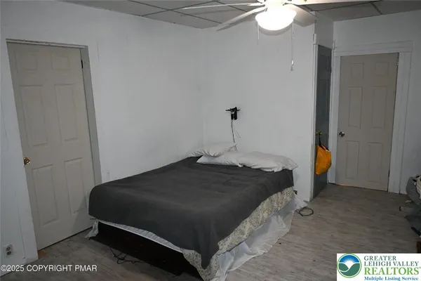 a bedroom with a bed and a chandelier