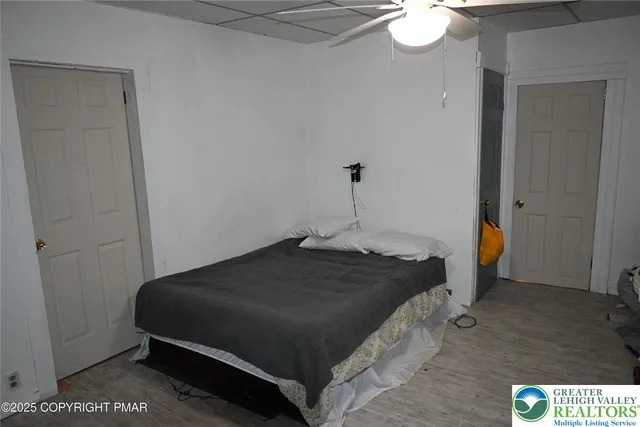 a bedroom with a bed and a chandelier