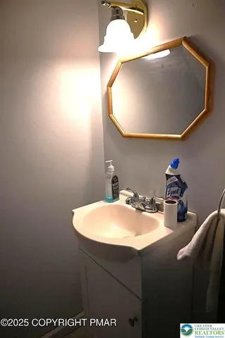 a bathroom with a sink vanity and a mirror