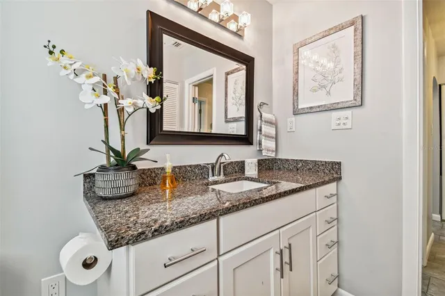 a bathroom with sinks granite and a mirror