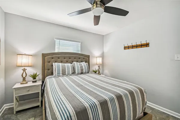 a bedroom with a bed and a lamp