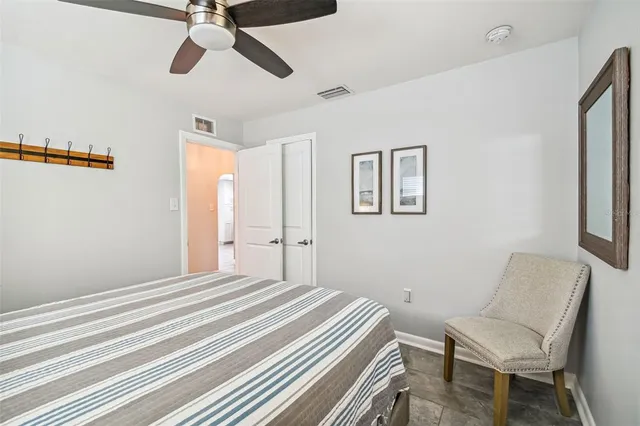 a bedroom with a bed and chair