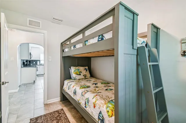 a bedroom with a bed and a mirror