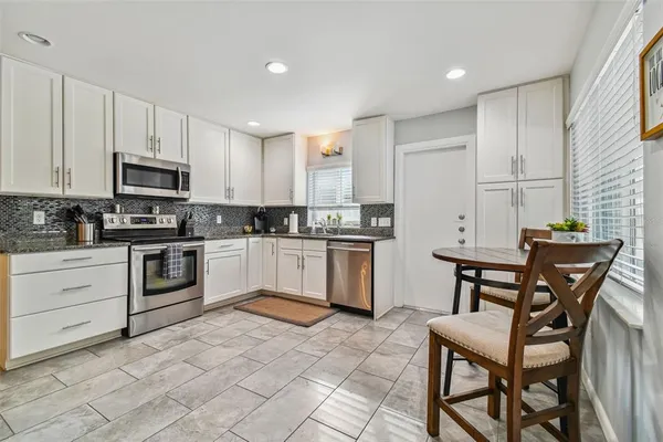 a kitchen with a stove a sink and a refrigerator