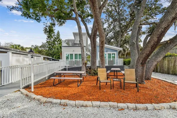 a view of a house with backyard porch and sitting area